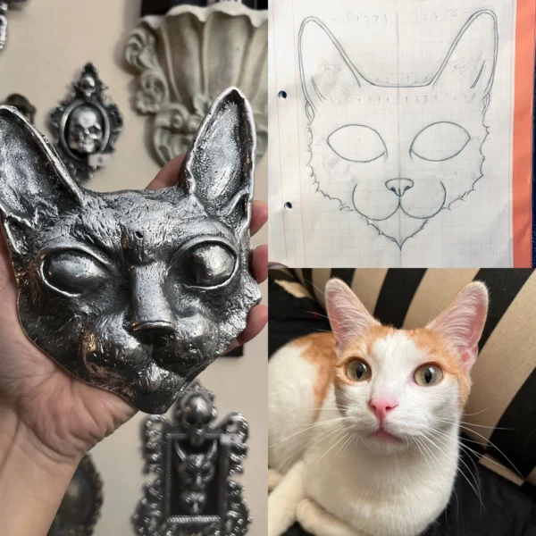 Máscara de gato artesanal en tono plateado, ideal para un toque elegante y oscuro en la decoración.
